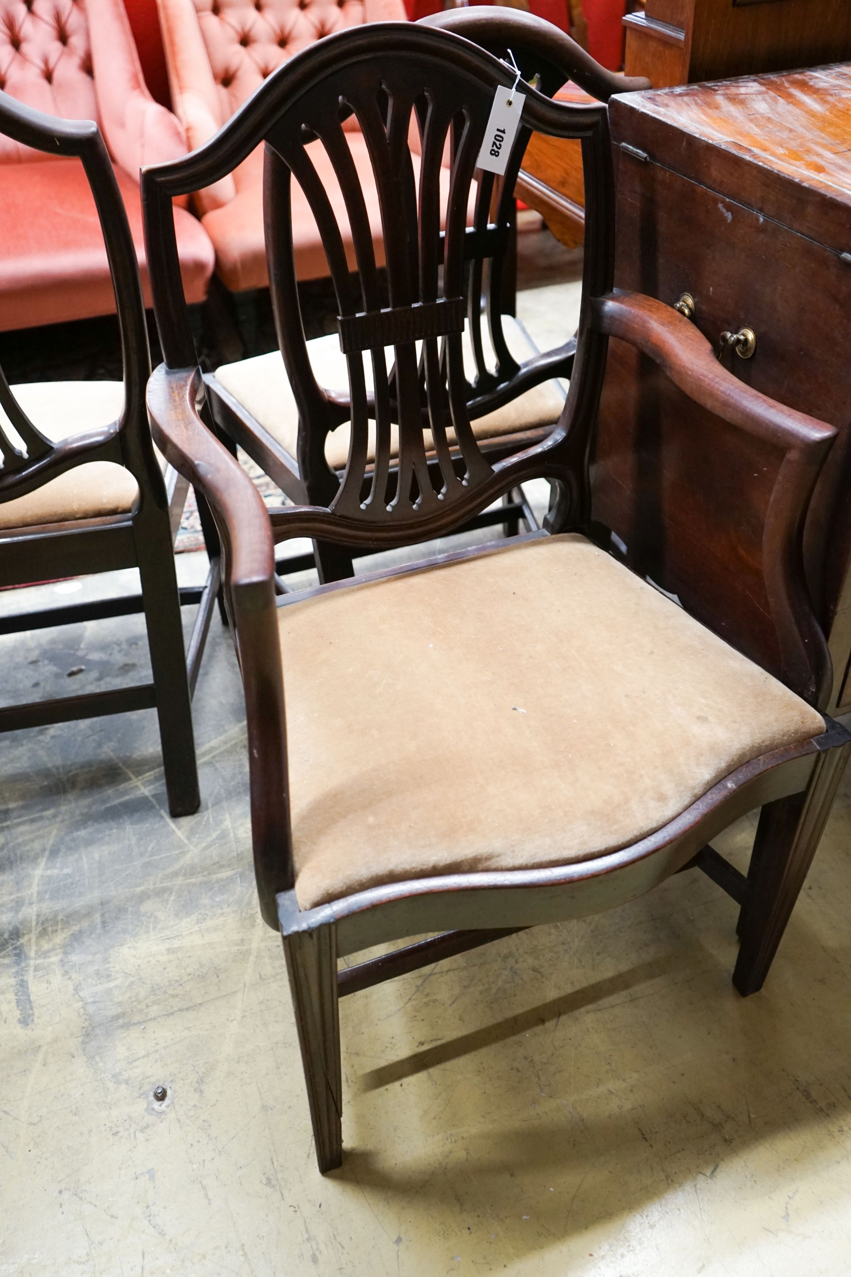 A set of six George III mahogany dining chairs (one with arms)